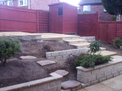 Tiered Garden, granite walls with coping Riven Slab patio and steps 003.jpg